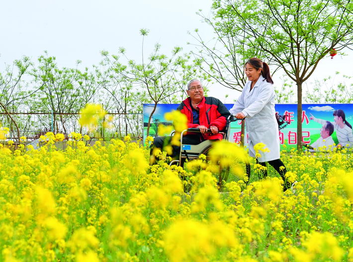 April 15, 2018: A senior in a wheelchair in Julu County, Hebei Province, is aided by a nurse. In recent years, China has placed more attention on addressing the needs of its booming elderly population.  by Mou Yu/Xinhua